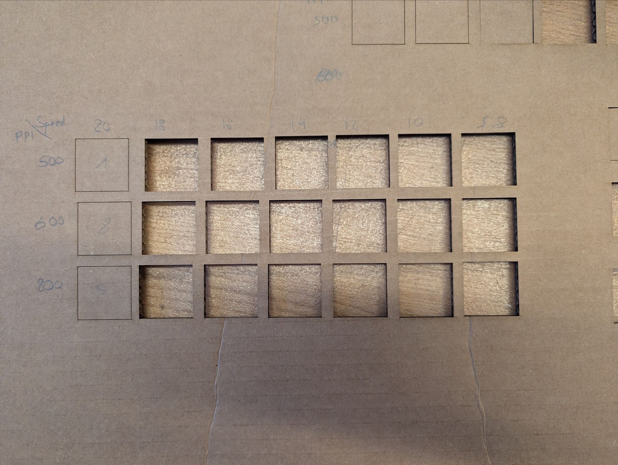 Figure 3: Cut cardboard after lifting and pushing out squares by hand.