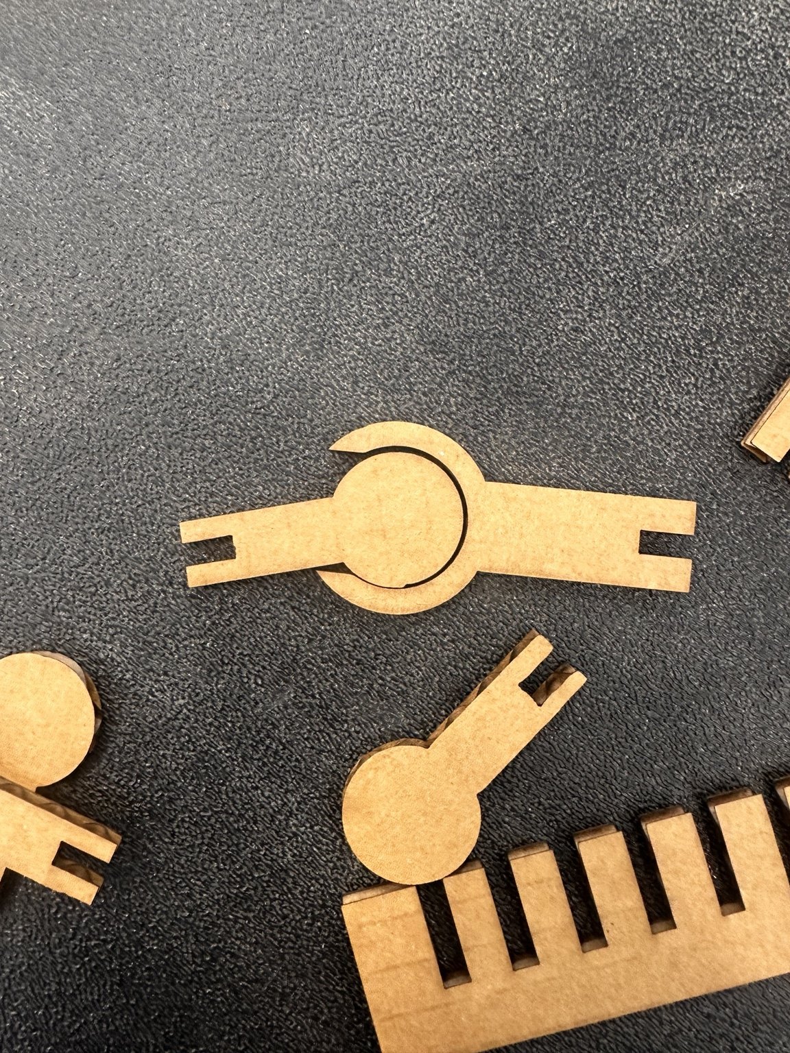 Early circular snap-fit joint beside a slot-tolerance test comb