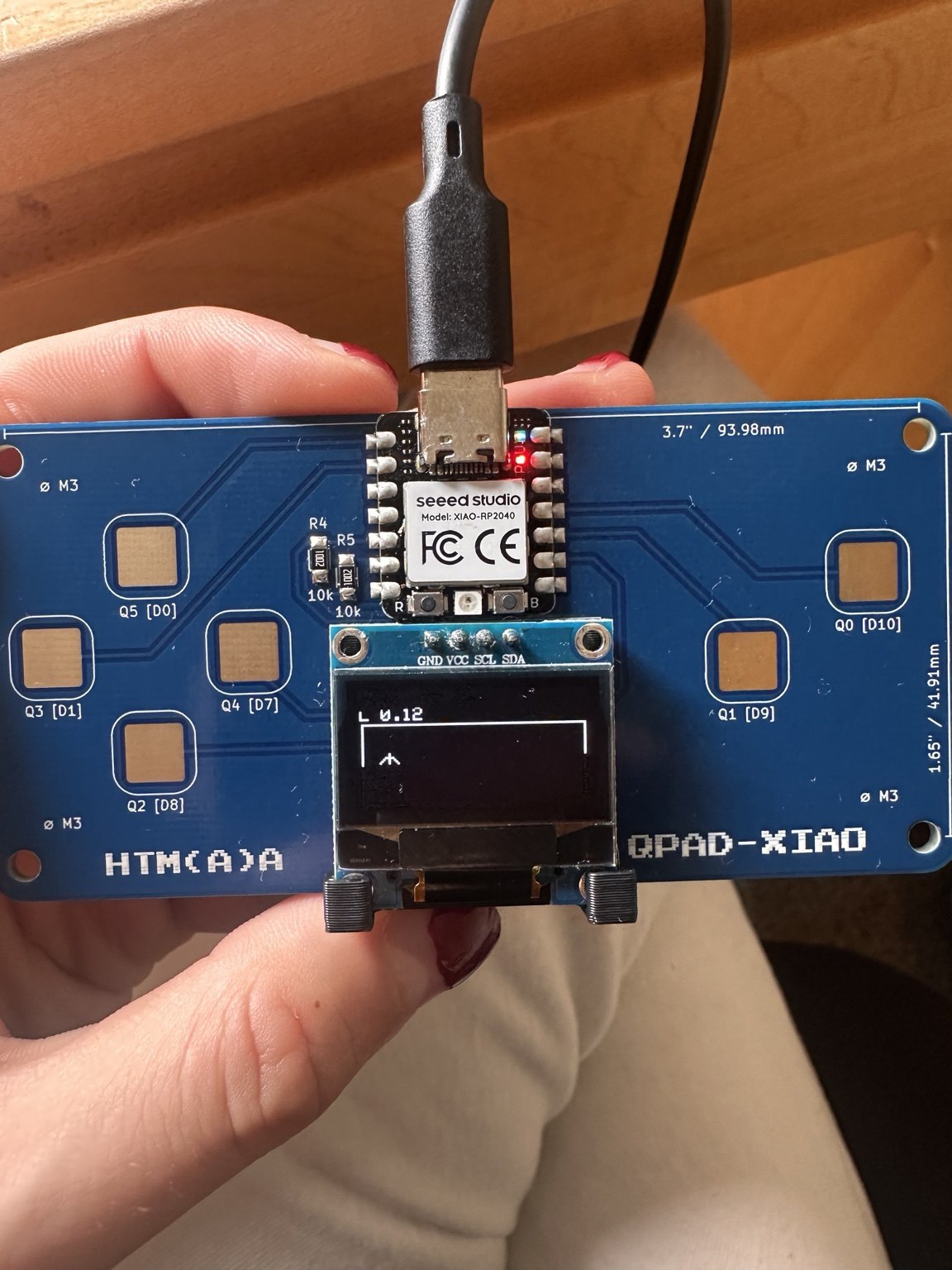 QPAD OLED displaying L 0.12 during the swimmer training run