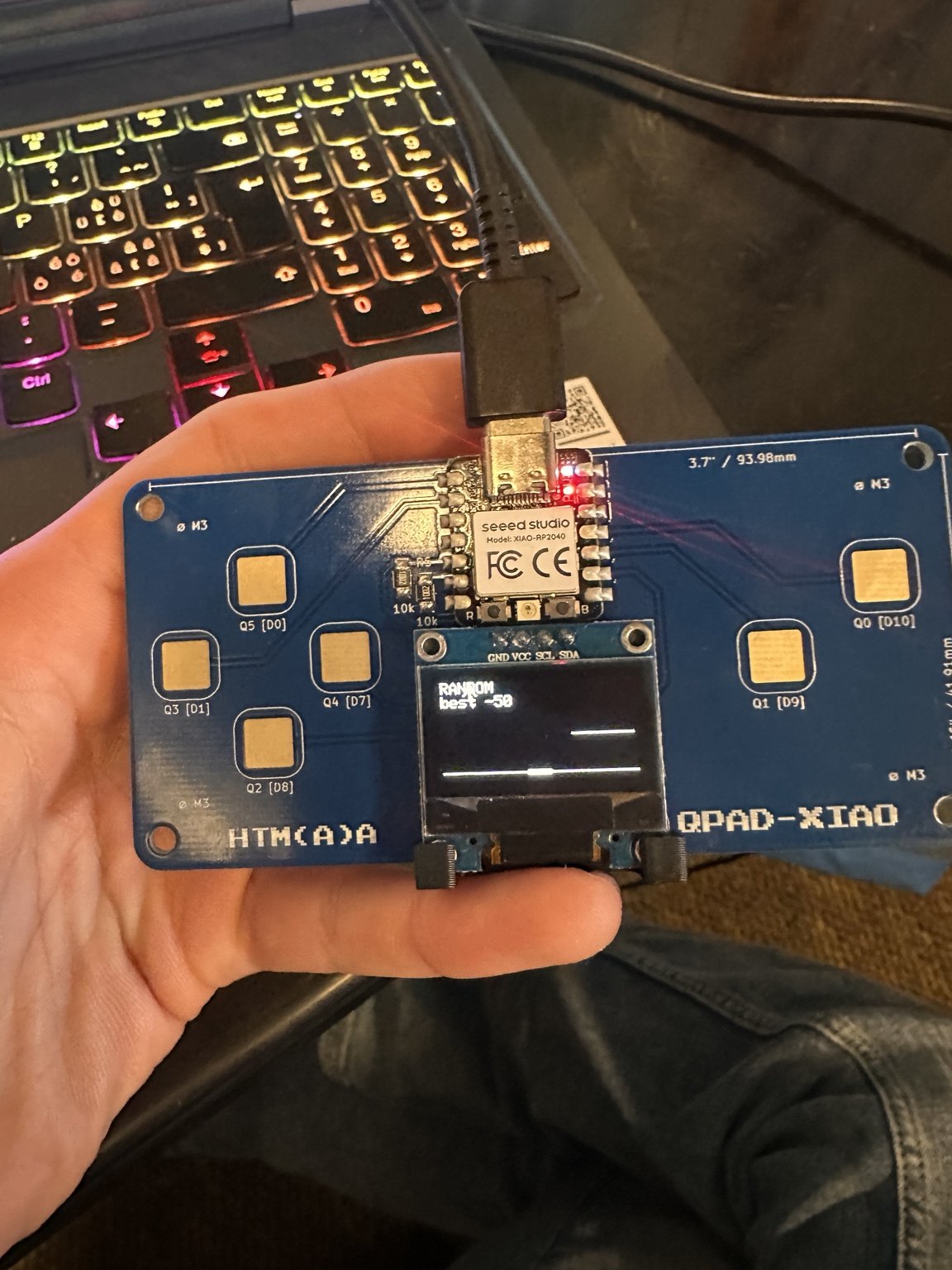 QPAD-OLED running RANDOM mode on the handheld board