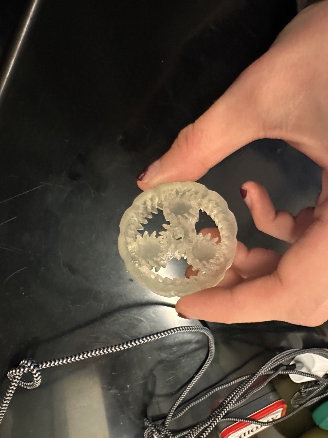 Real translucent resin planetary gearbox, held up to show the printed gears