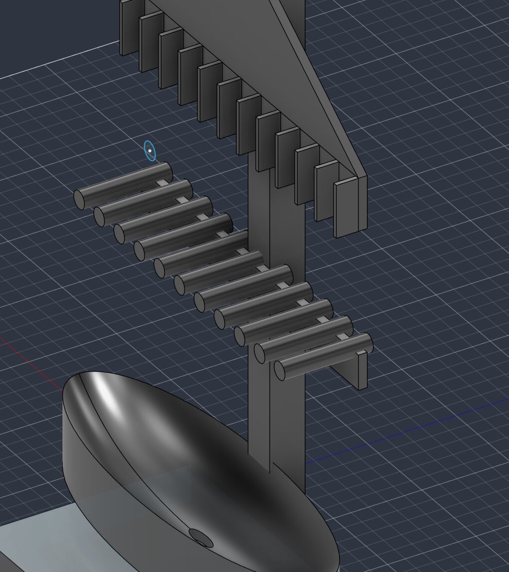 CAD view of a descending row of cylindrical pipes arranged in a staircase beneath the guide fins
