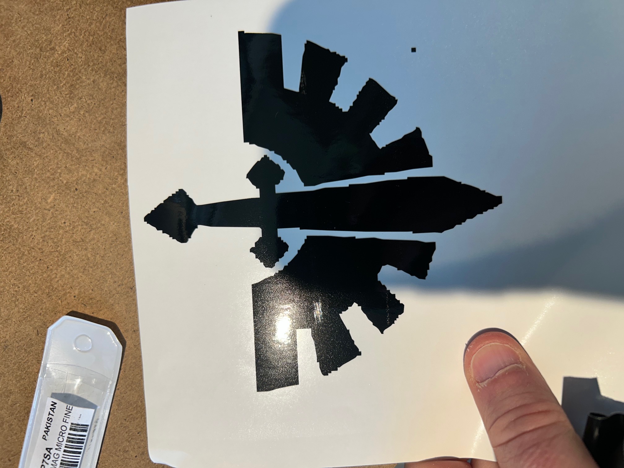 The finished black Dark Angels decal weeded and sitting on its white backing paper