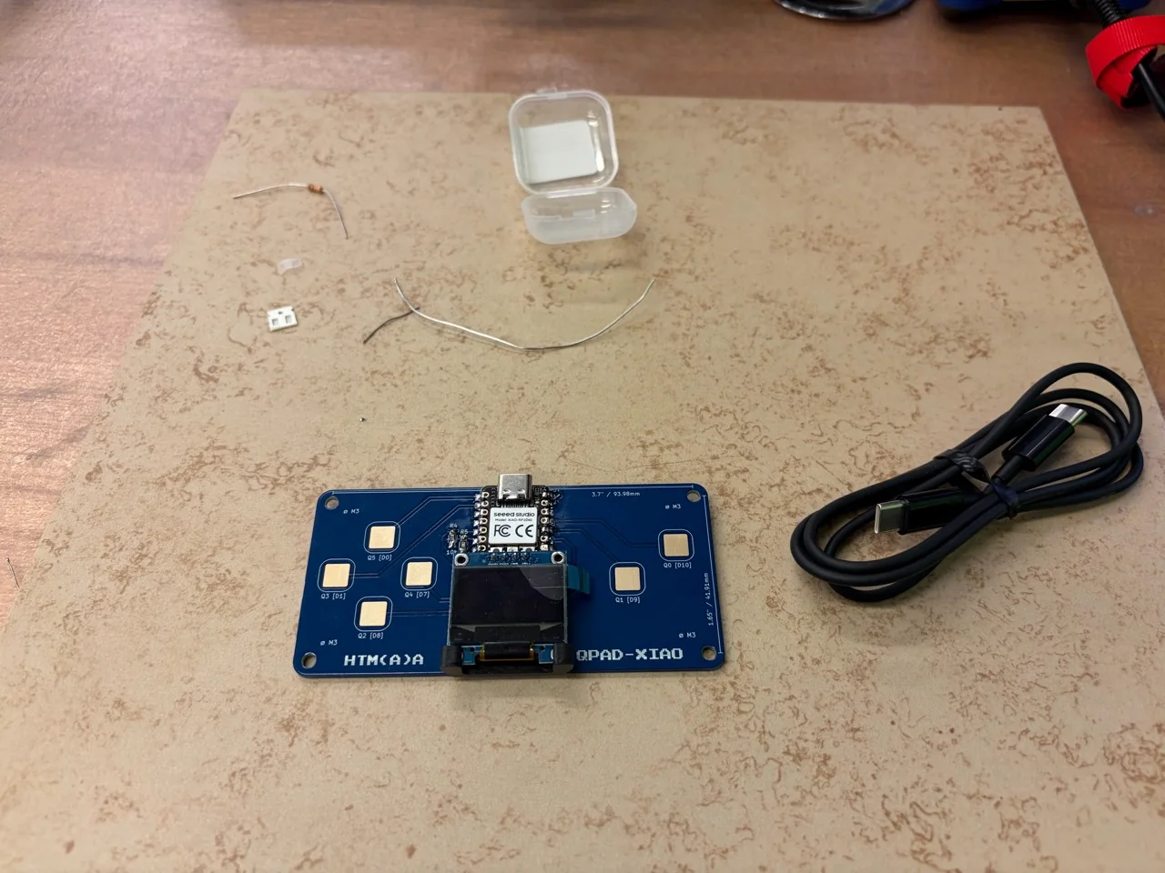 Assembled QPAD-XIAO with six touch pads, XIAO RP2040 and OLED on the electronics bench