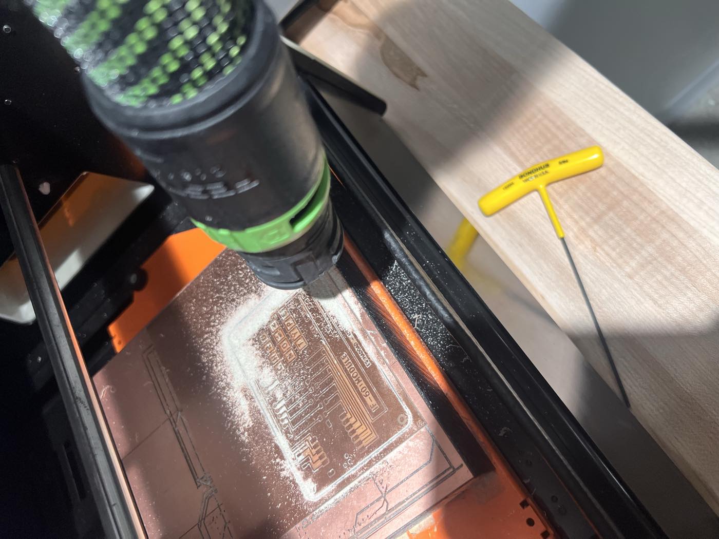 Vacuuming the copper dust after the traces pass