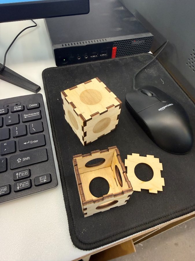 Finished finger-jointed cube with engraved circles on its faces