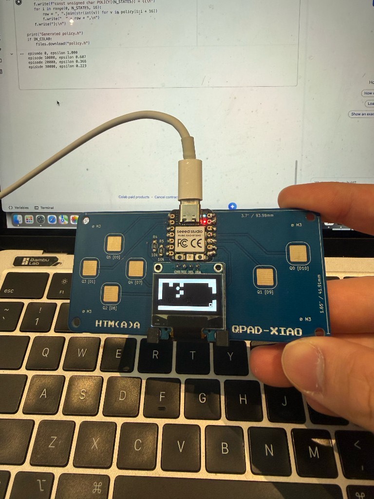 QPAD-XIAO running the Q-learning gridworld on the OLED