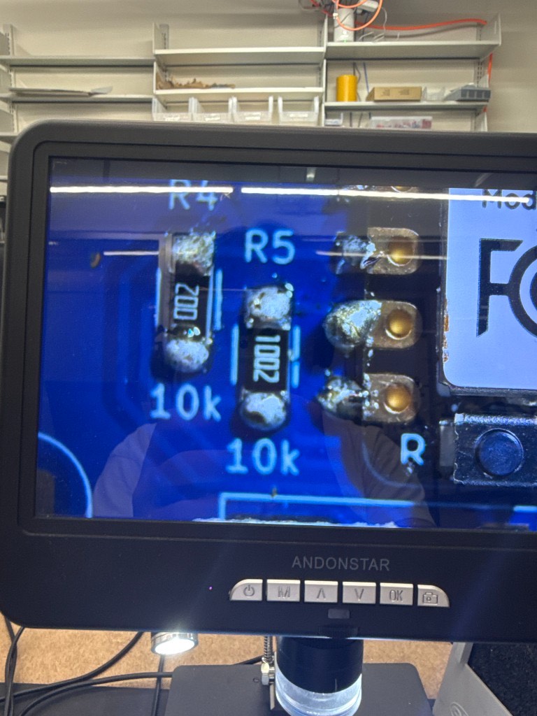 Microscope view of two 10k surface-mount resistors soldered at R4 and R5