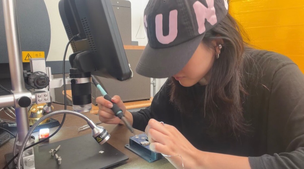 Soldering a circuit board under a microscope