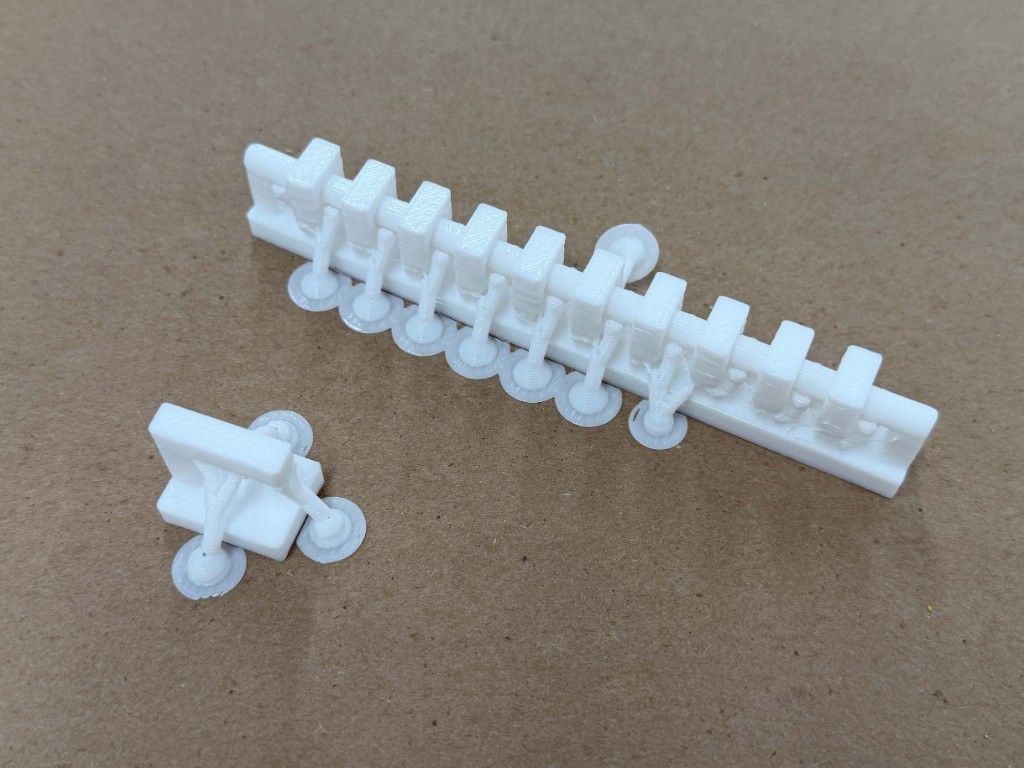 White printed bridging test with spans between posts, one span broken off