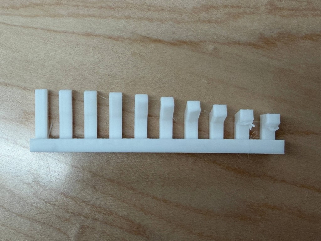 White printed row of vertical fins that get shorter and start to fail