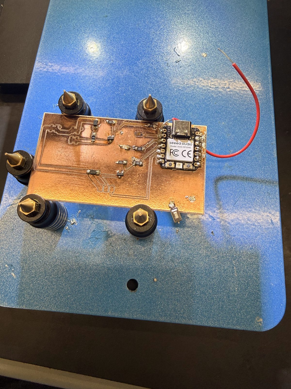 Board in the holder with components soldered