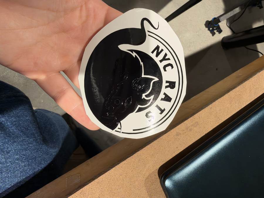 Peeling away the excess vinyl from the sticker
