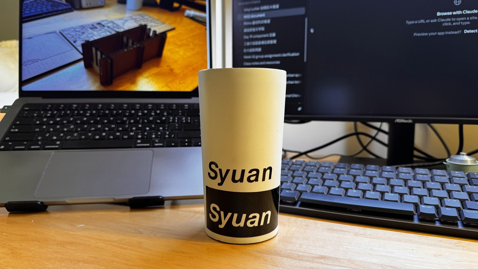 Two vinyl name stickers applied to a white cup