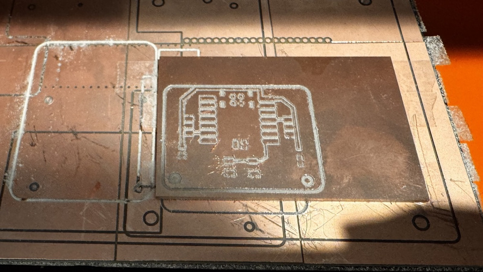 Version 2 board on the milling machine bed after milling, with the longer XIAO pads visible
