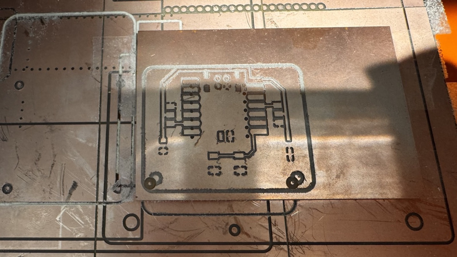 Version 2 board on the machine after milling, with the drill holes shifted from where they should be relative to the traces