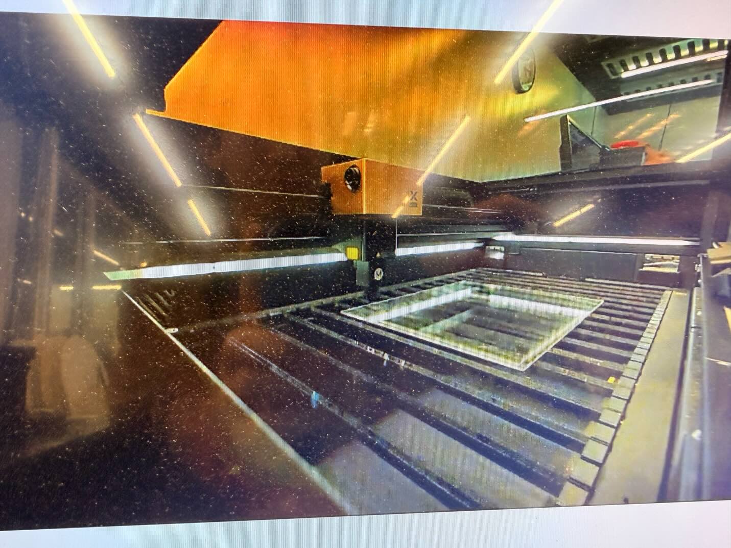 Transparent acrylic sheet inside the laser cutter during fabrication