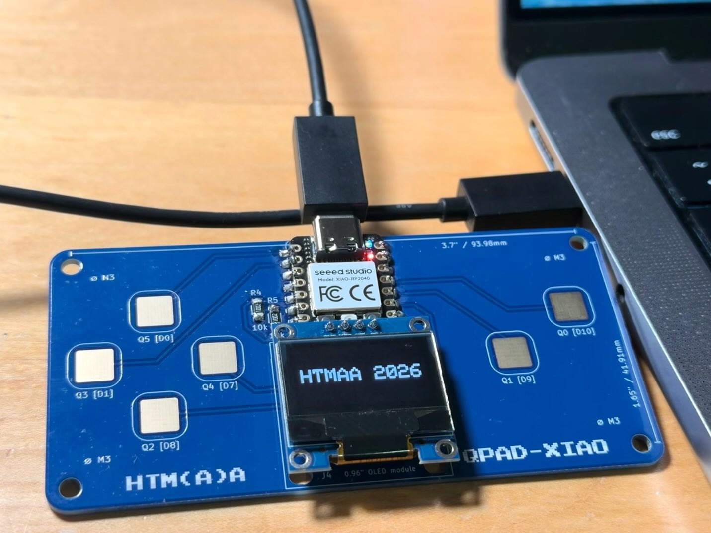 QPad-XIAO OLED display reading HTMAA 2026 after the first sketch was uploaded