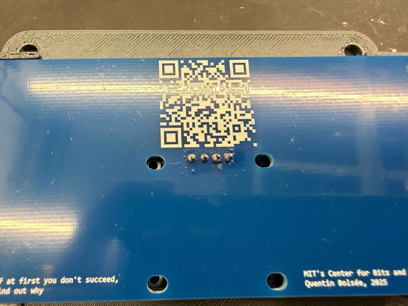 Back of the blue board showing the OLED's four solder joints
