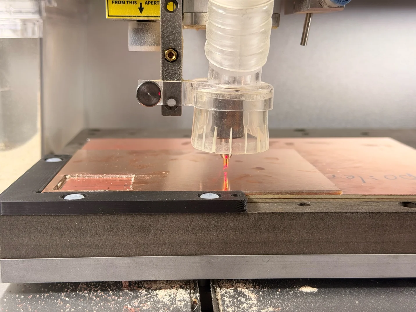 Carvera spindle and laser pointer above the copper-clad stock