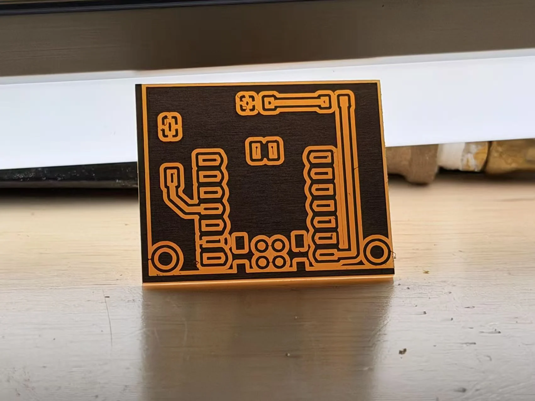 The first milled board with the copper pattern reversed after an image inversion mistake