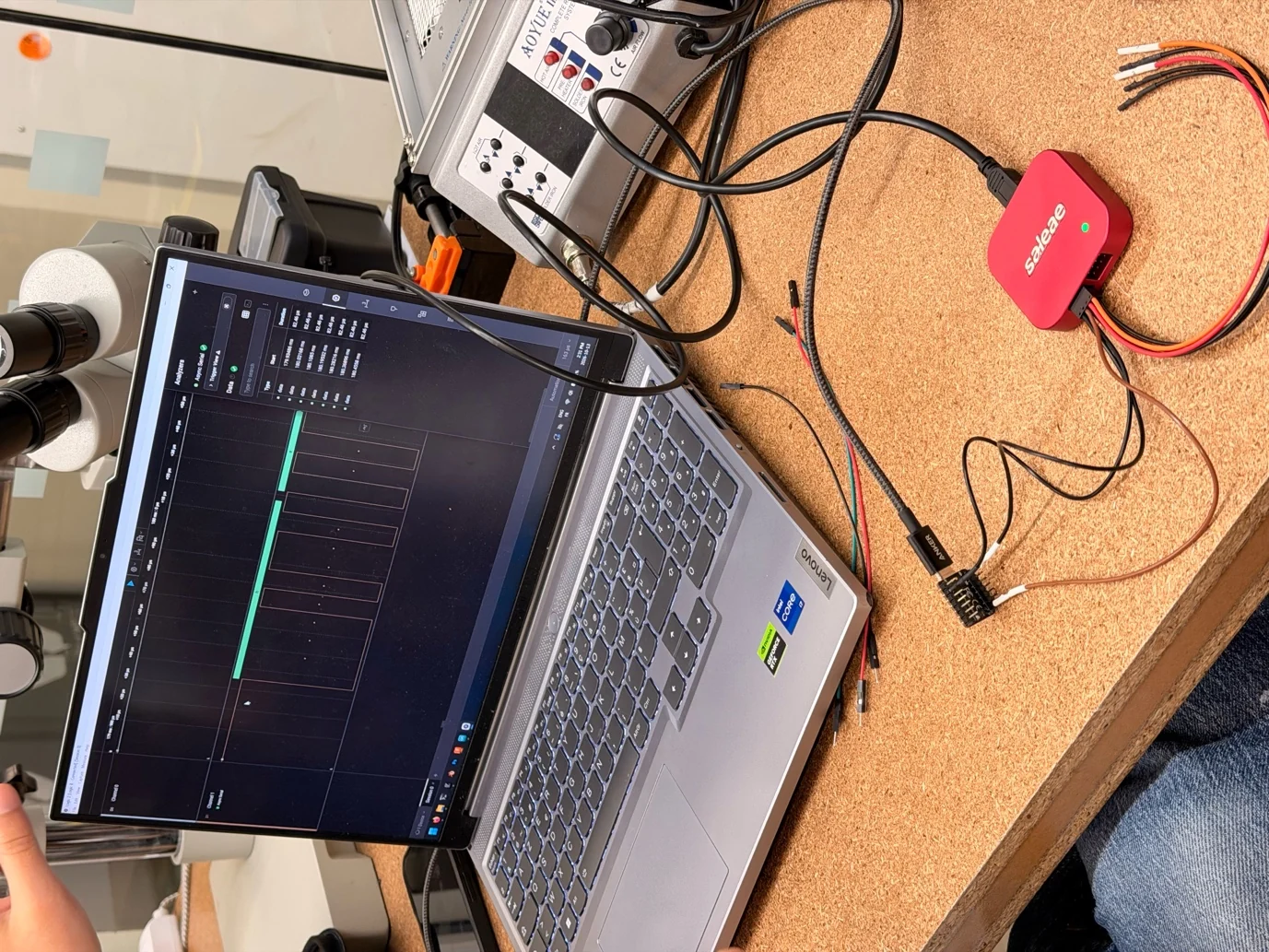 A logic analyzer connected to a laptop showing captured digital signals