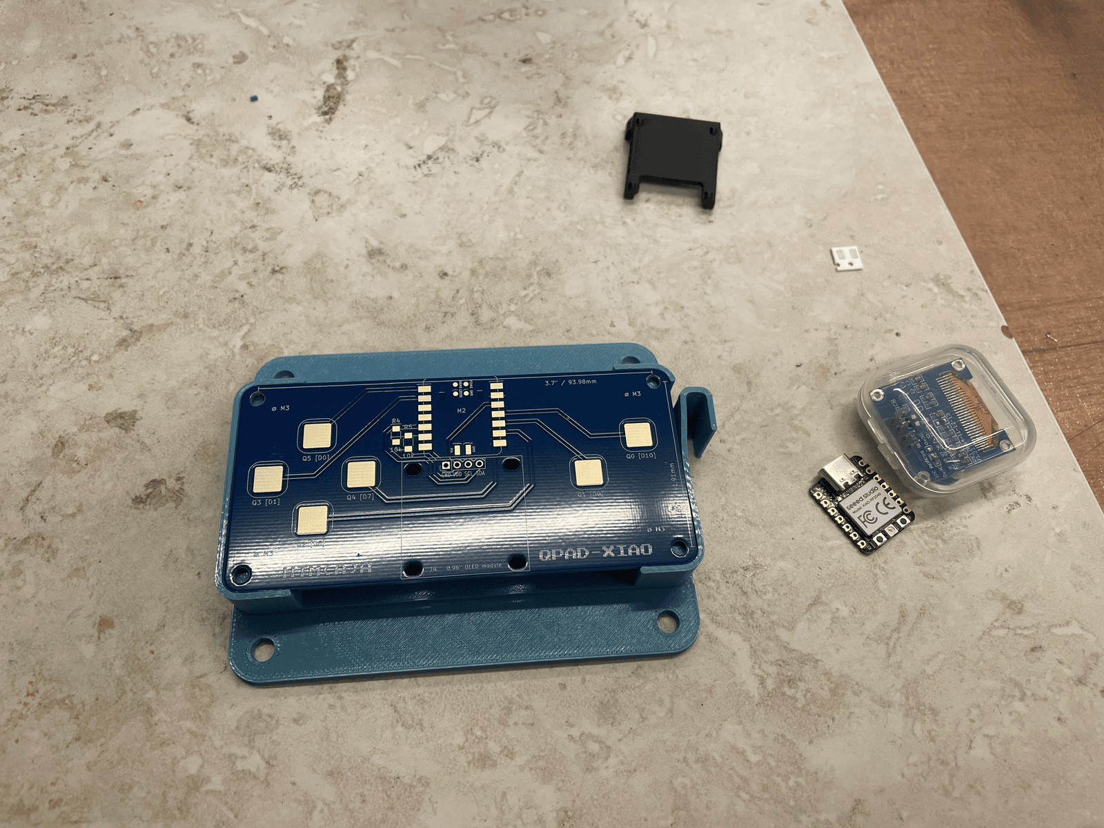 QPAD-XIAO board, XIAO RP2040, OLED, and parts before assembly