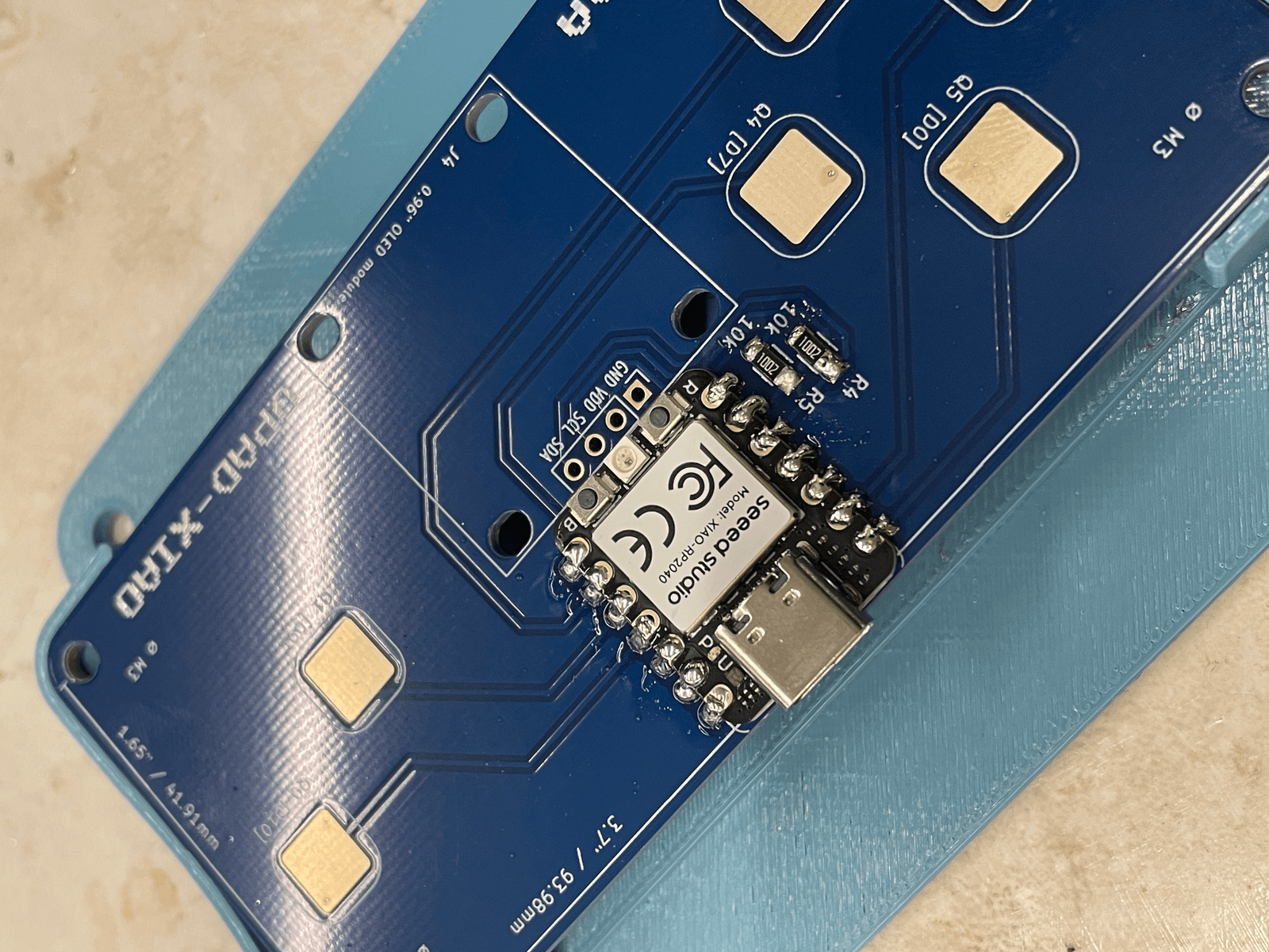 Close view of the XIAO RP2040 soldered onto the QPAD board