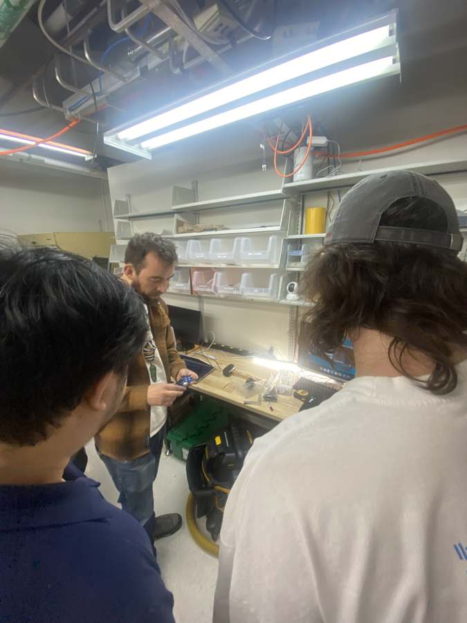 Quentin explaining the QPad to a group of students in the lab