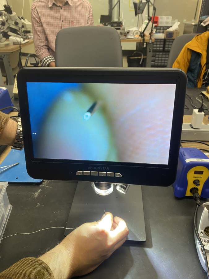Microscope screen showing the tip of the flux-core solder wire
