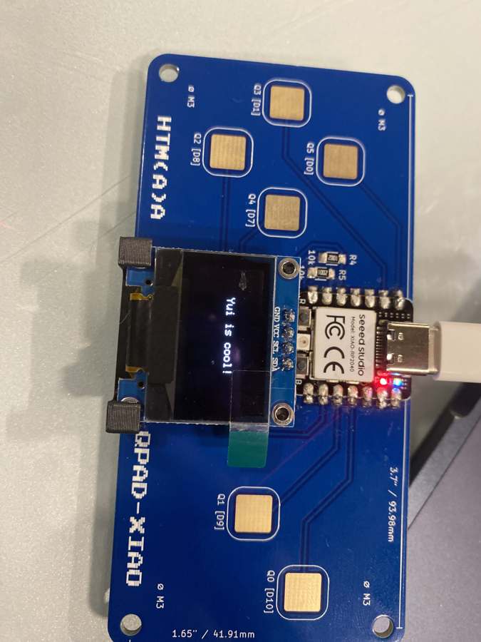 The OLED showing the text Yui is cool!