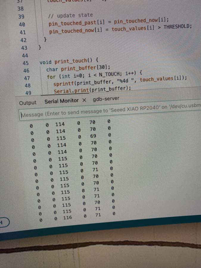 Serial Monitor showing touch values, with one column around 115 and another around 70