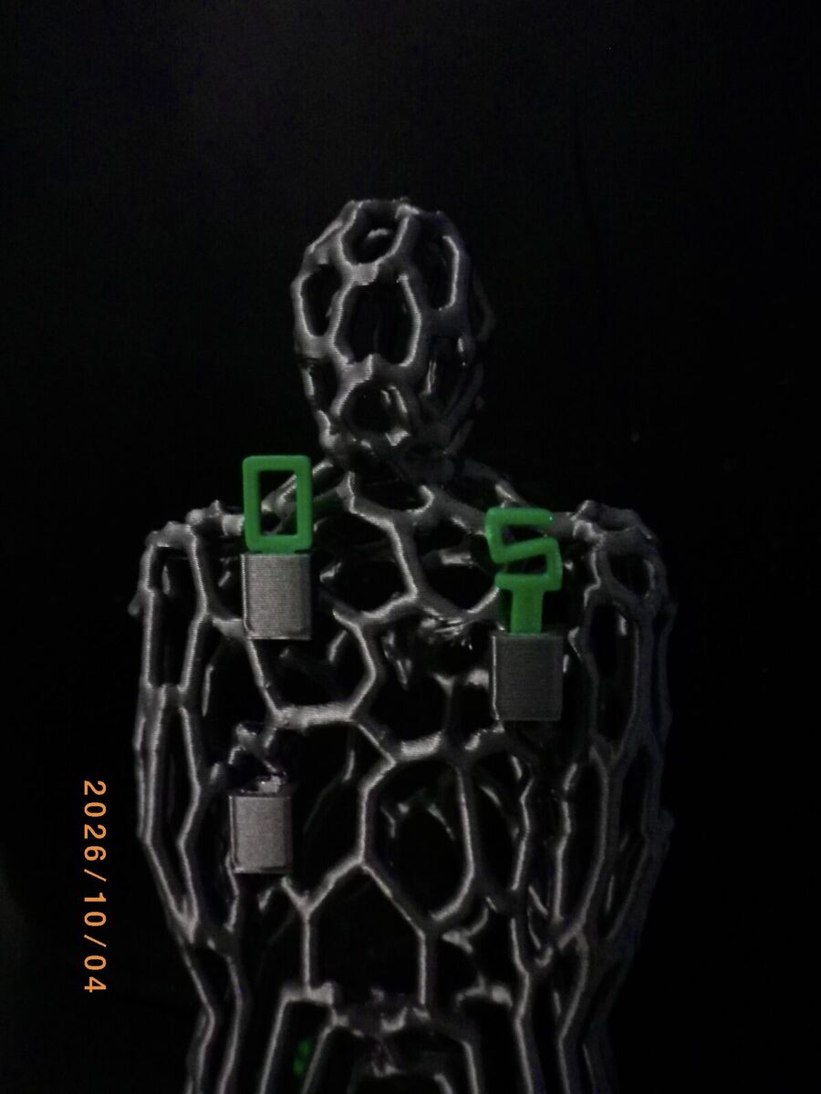 Close-up of the lattice figure's chest, with green number panels clipped on