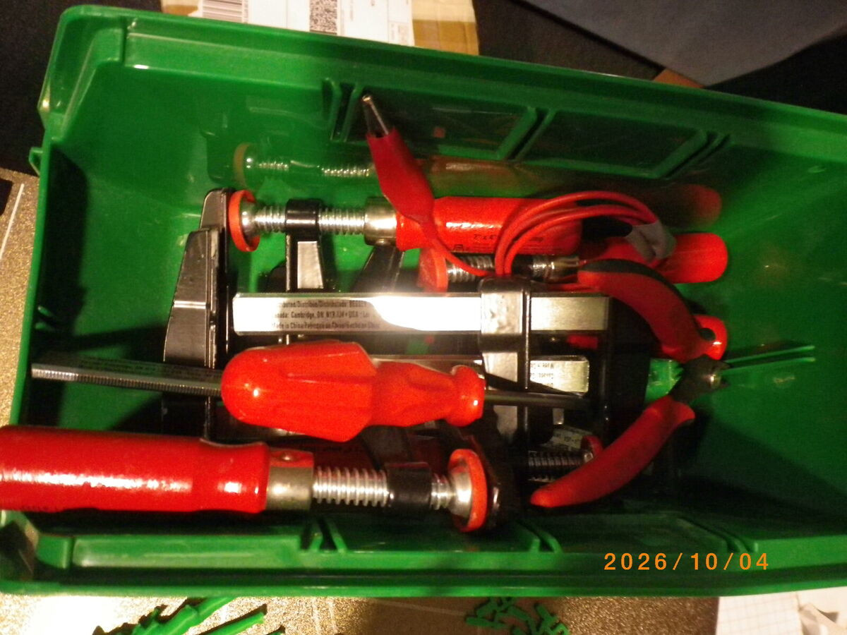 A green bin of clamps, pliers and flush cutters