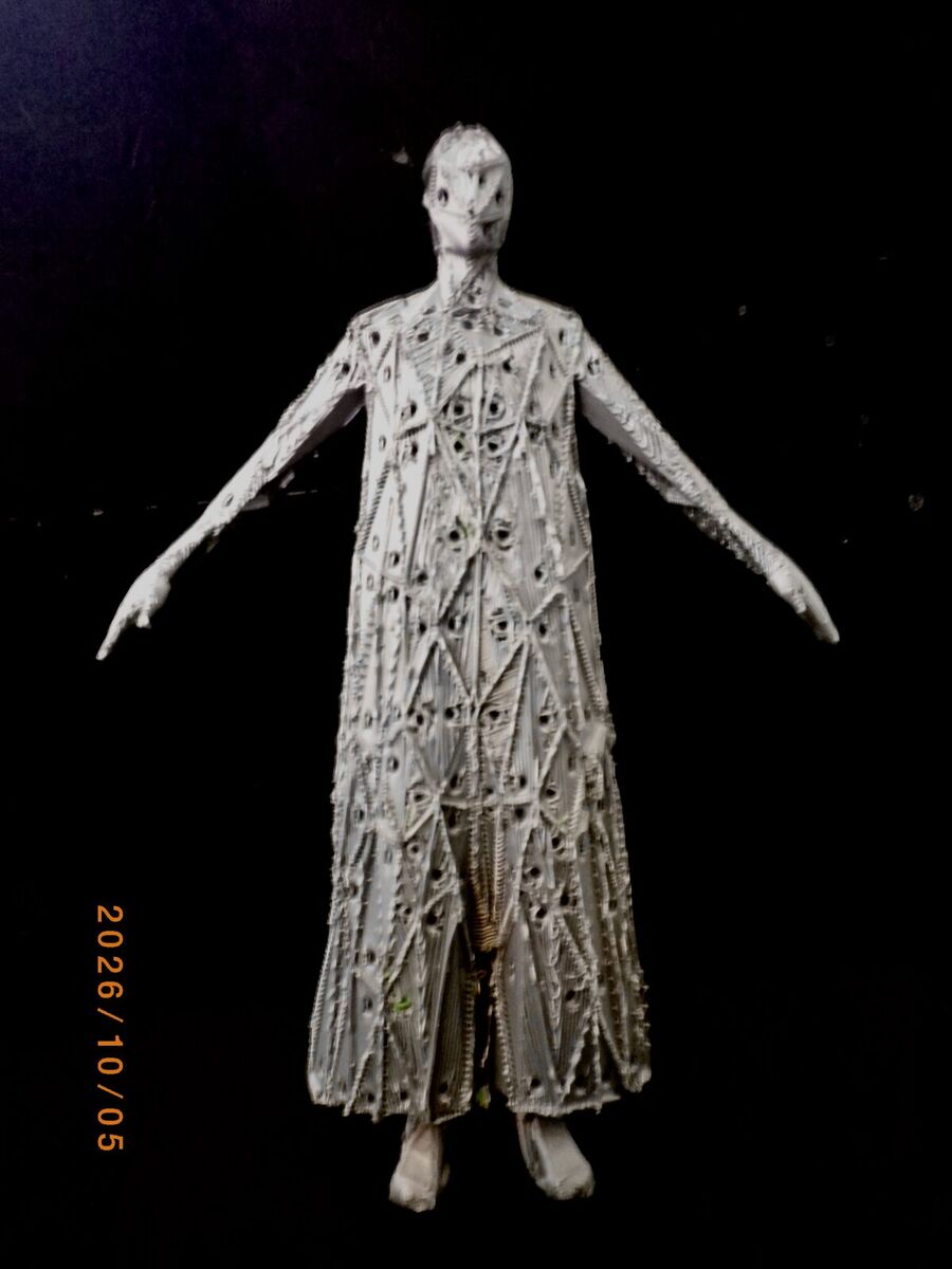 The gray figure with arms out, standing against a dark background with its supports removed
