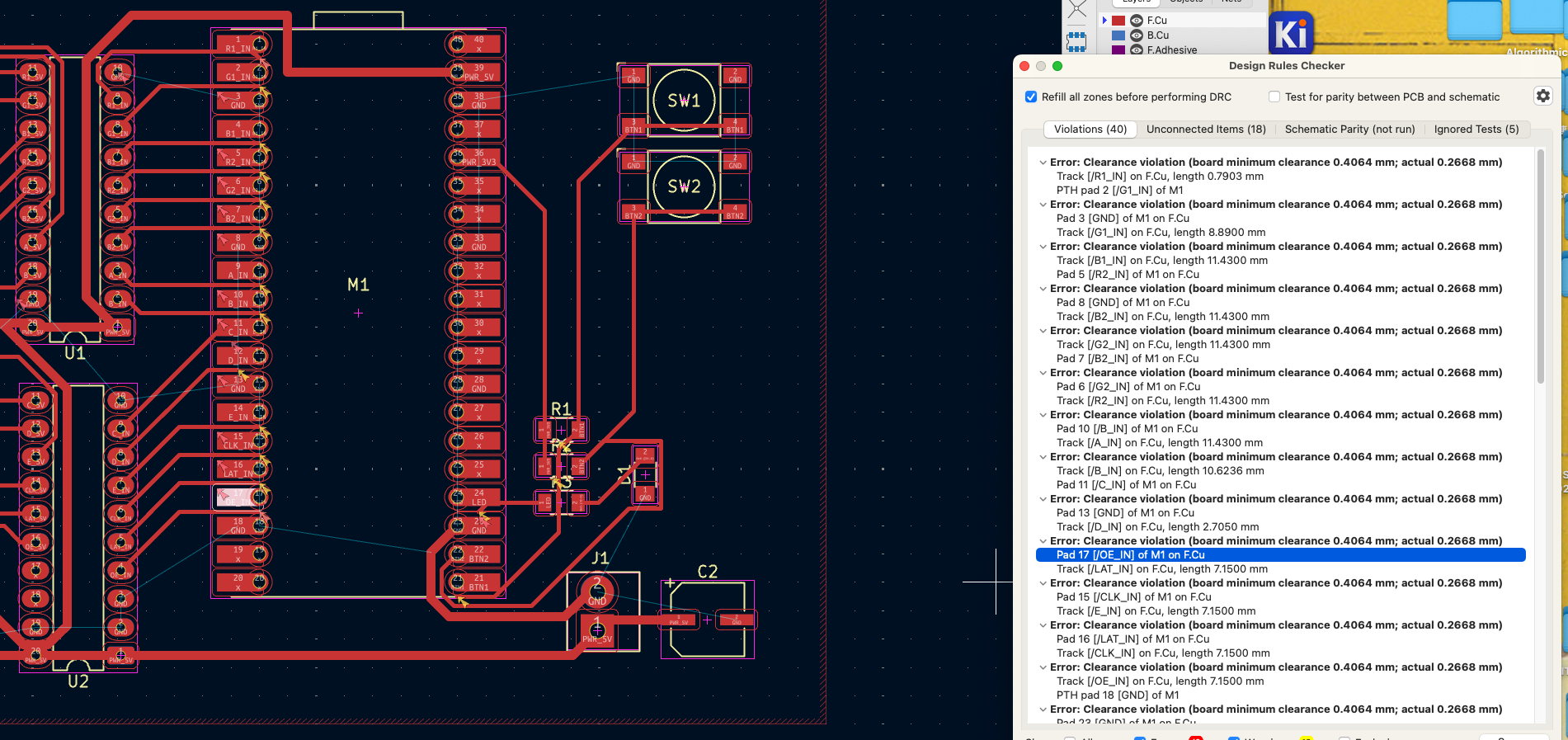 Routed traces next to the Design Rules Checker listing clearance violations of 0.2668 mm against a 0.4064 mm minimum