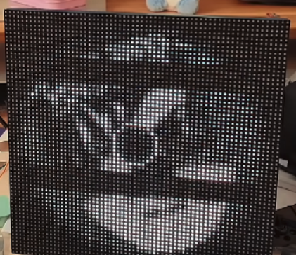A 64×64 LED matrix showing a grayscale album cover