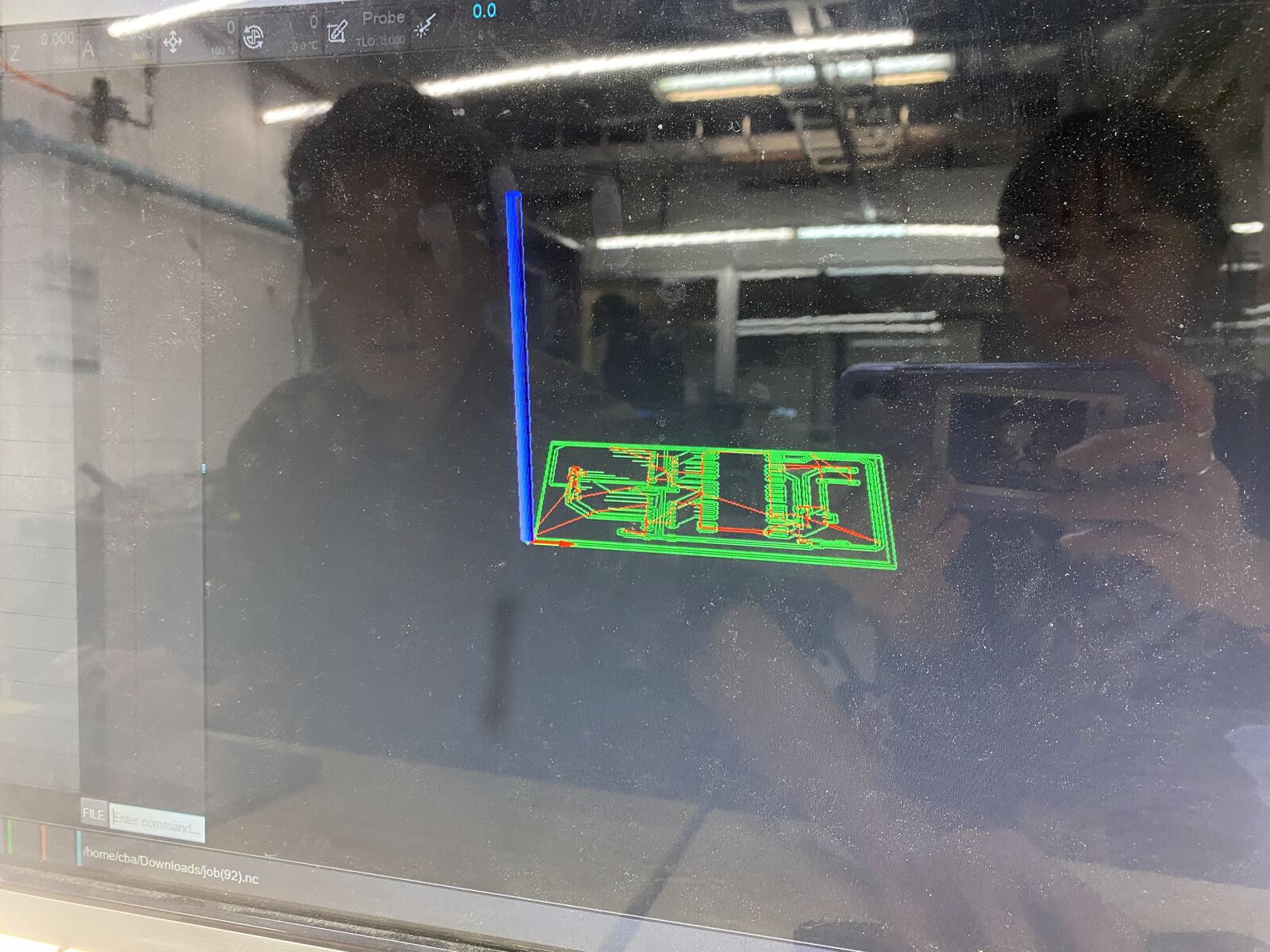 The Carvera milling the board, seen through the window