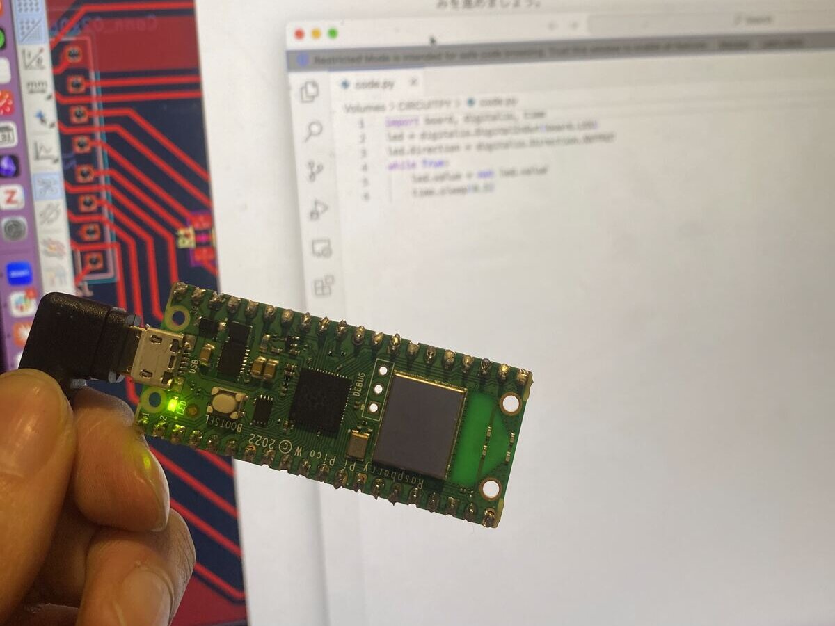 The Pico W connected over USB, with code.py open on the laptop