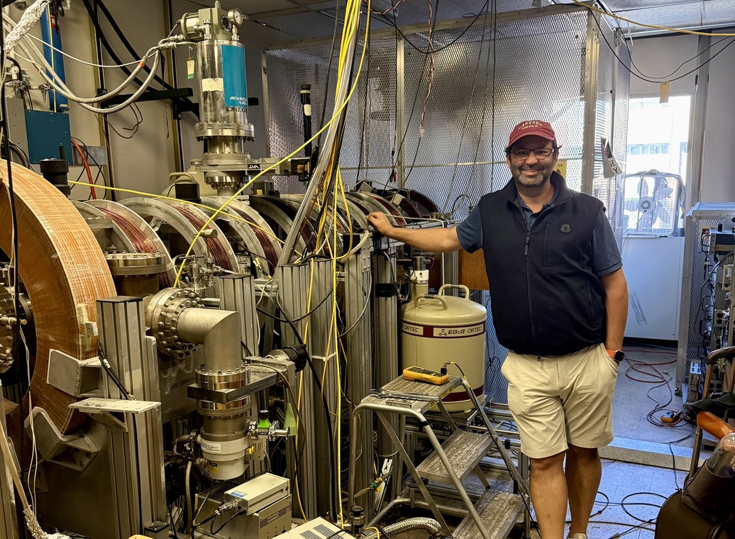 Researcher standing beside laboratory equipment used in the defect-state research project